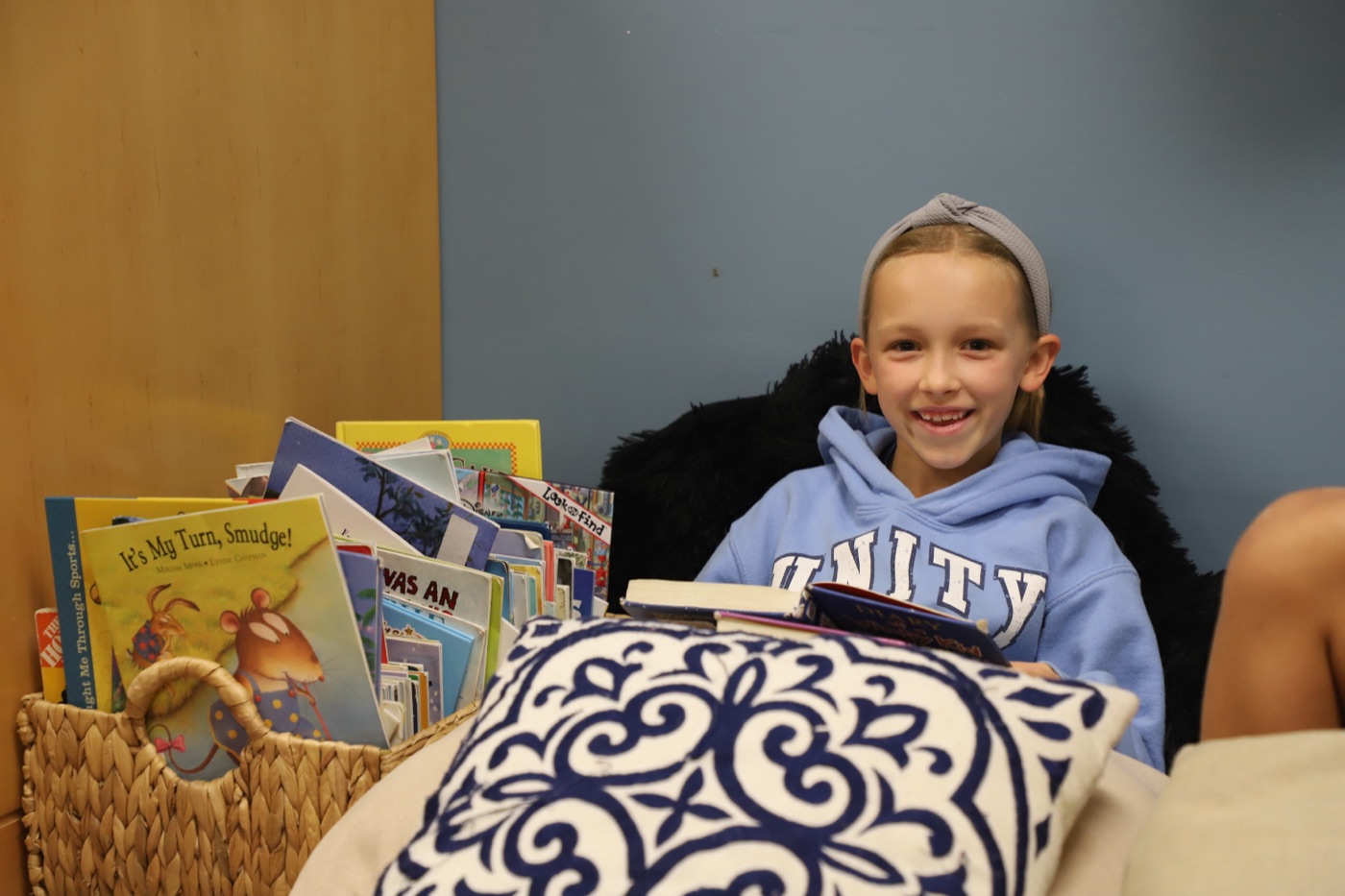 A Unity student with a basket of books