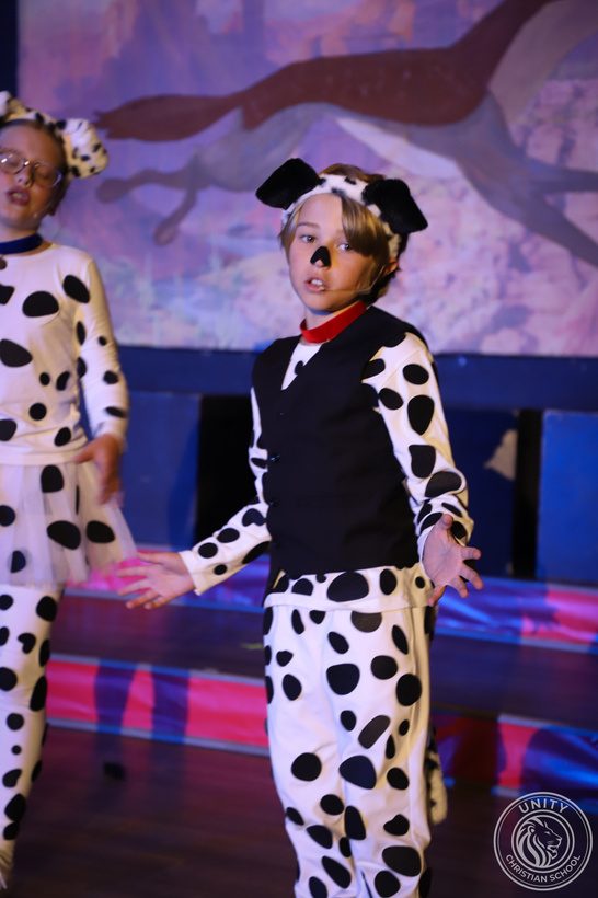 A student in a dalmatian costume performing