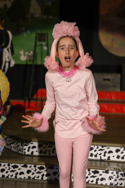 A student performing in a pink costume