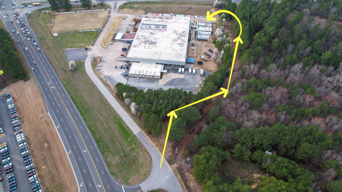 An aerial view of the Unity campus with the route of the new roadway marked
