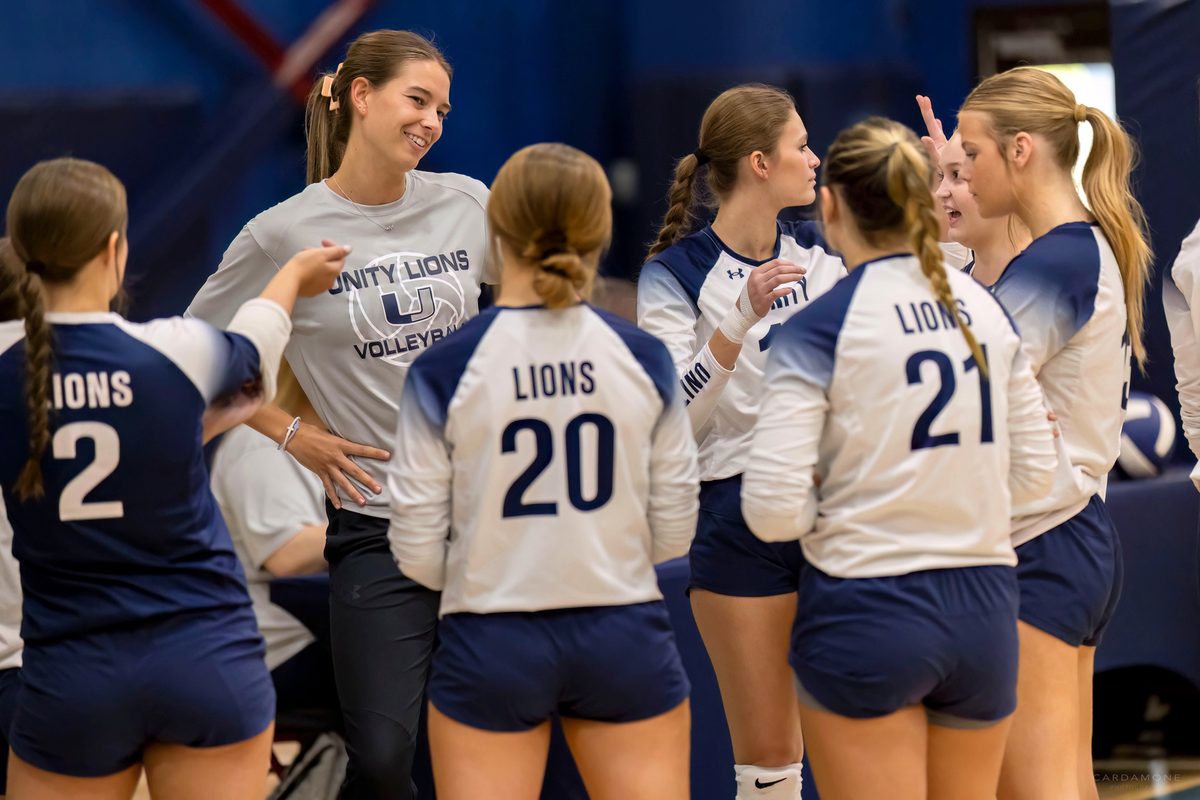 Coach Taylor Fisher with the varsity volleyball team