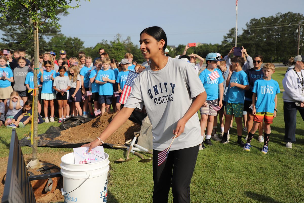 Seniors placing items into the time capsule