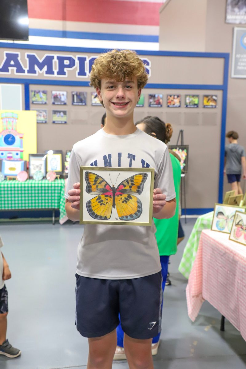 A student standing in front of the display grids