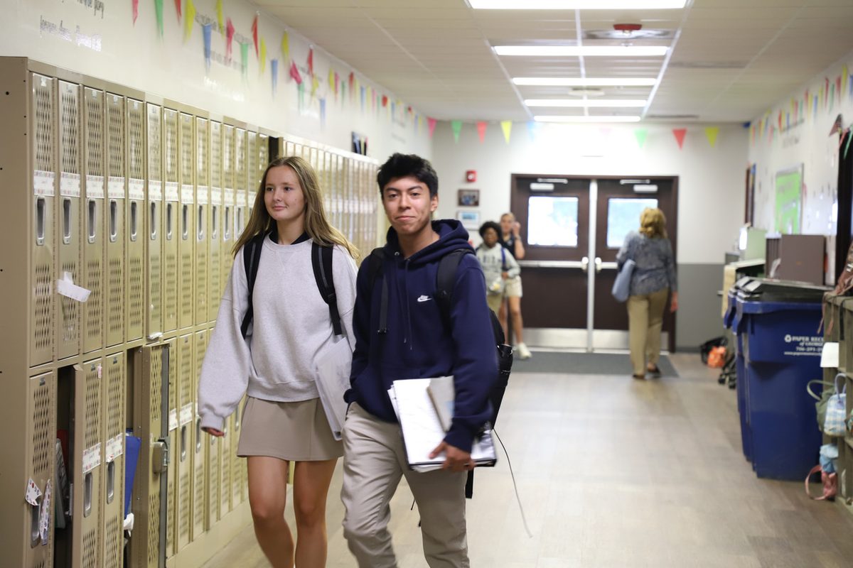 Two Unity students walking the hallway between classes